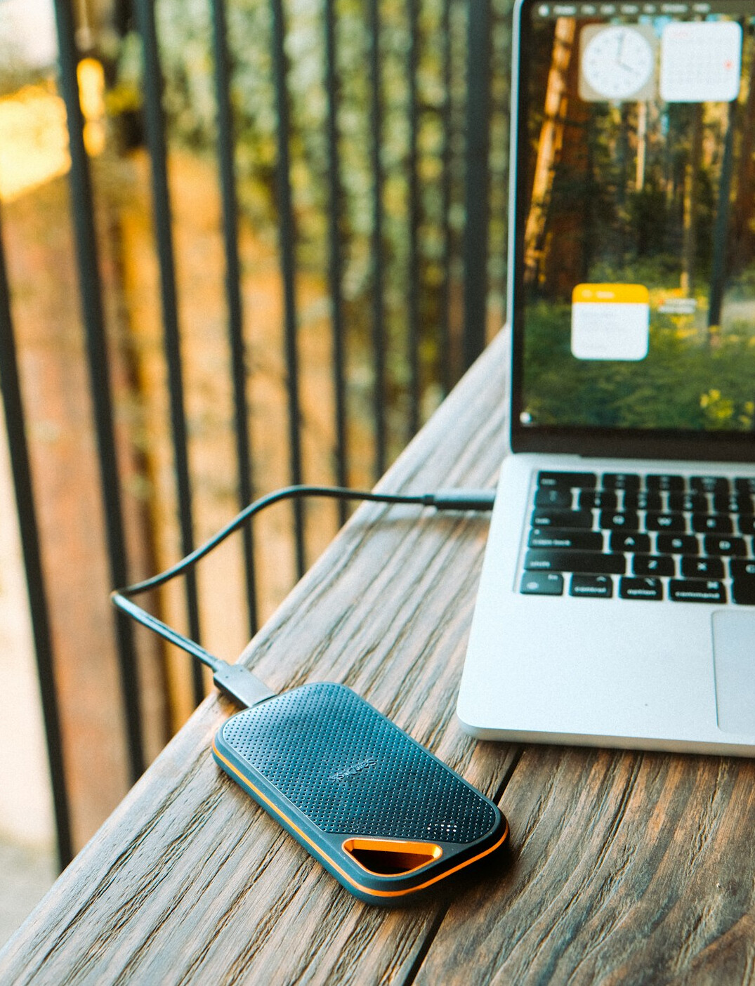 Open laptop with a blank notebook and pen on a desk