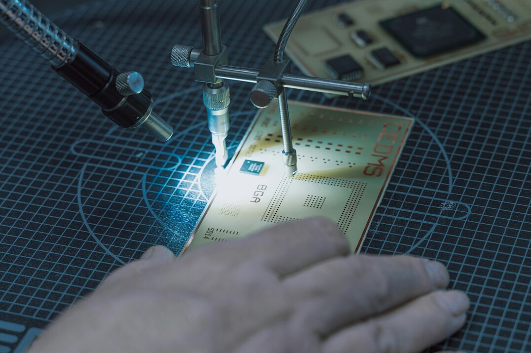 Close-up of hands verifying a document against a screen with data
