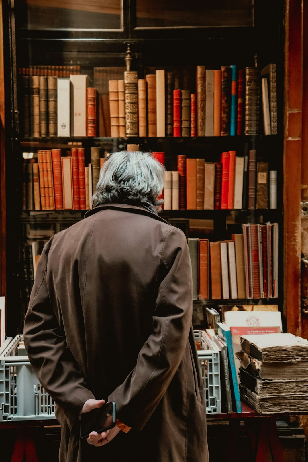 person reading old books in library